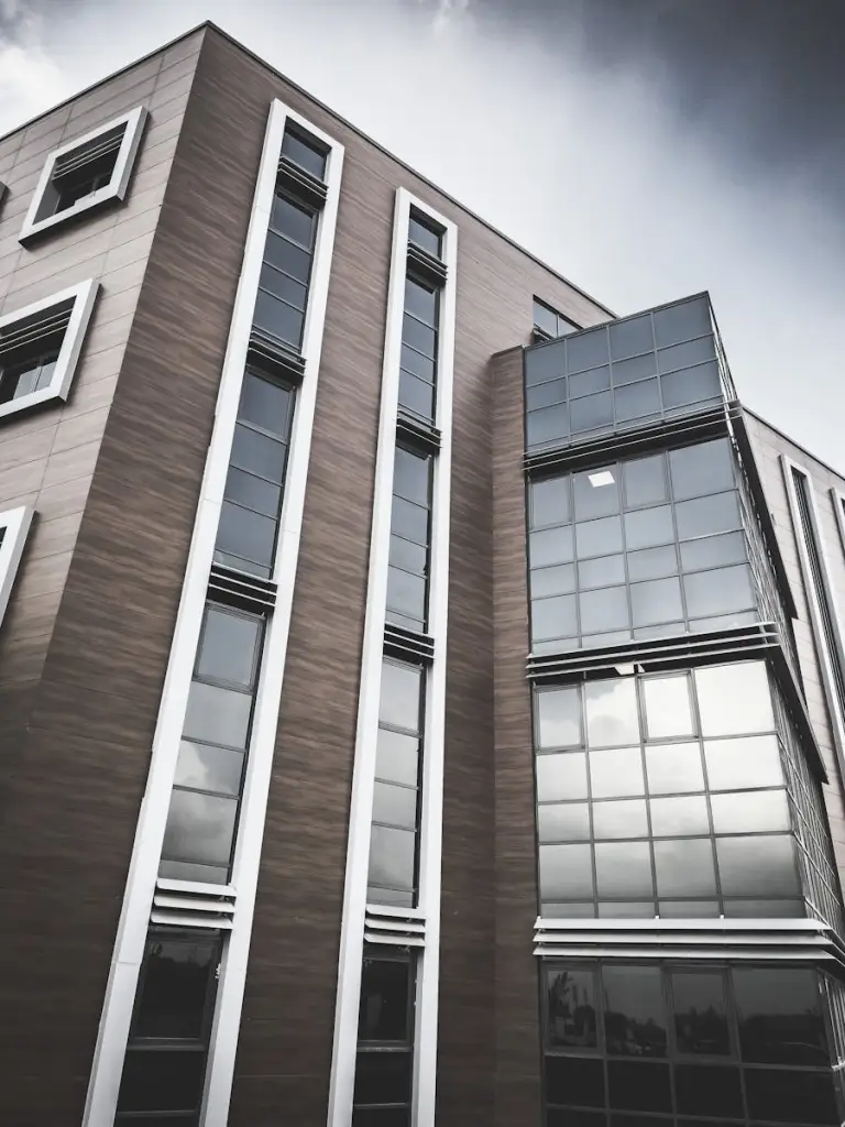 Low angle view of a modern office building facade with glass windows.