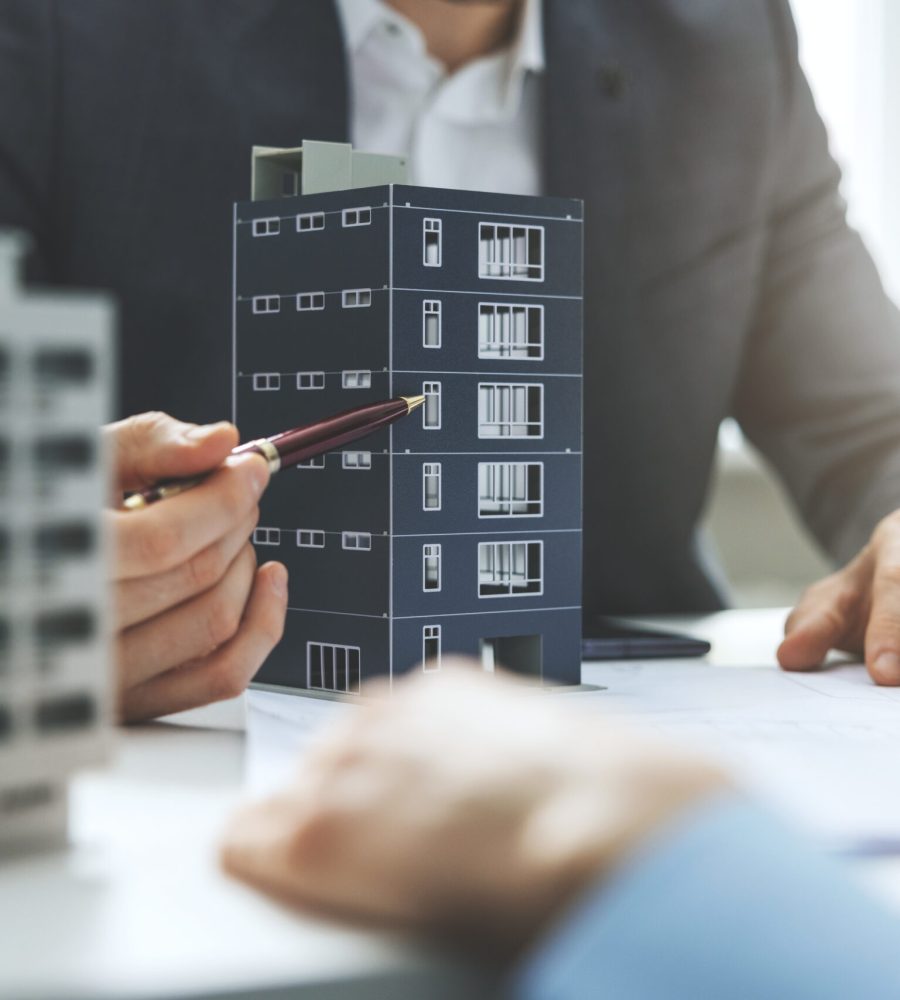 real estate developer and architect discussing new housing development project in office